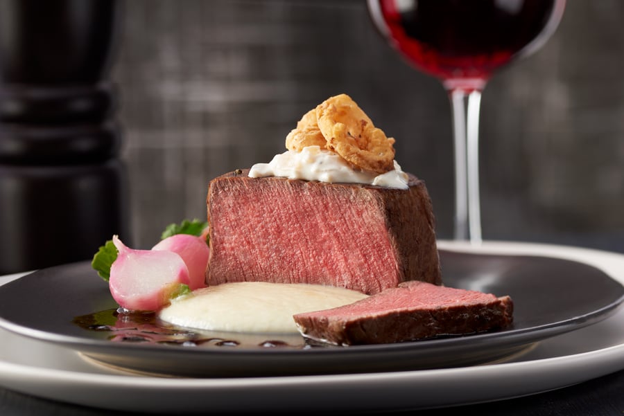 filet mignon at restaurant with glass of wine