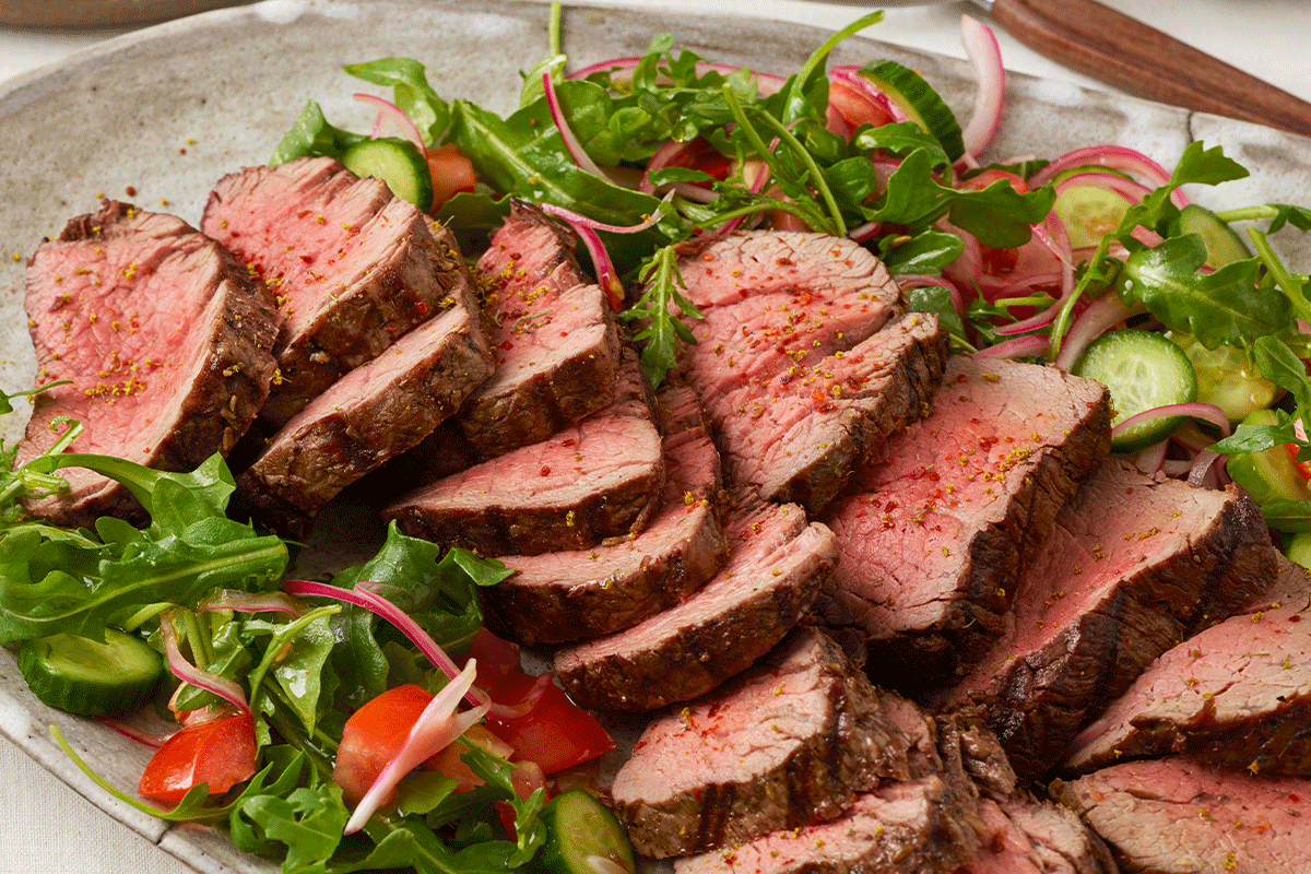 perfect beef tenderloin on a bed of greens