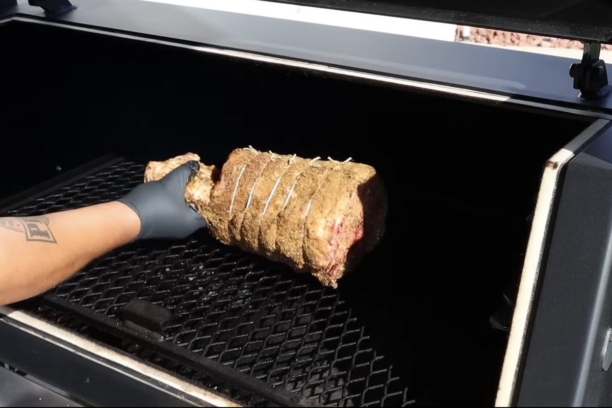 placing raw thor's hammer on the smoker