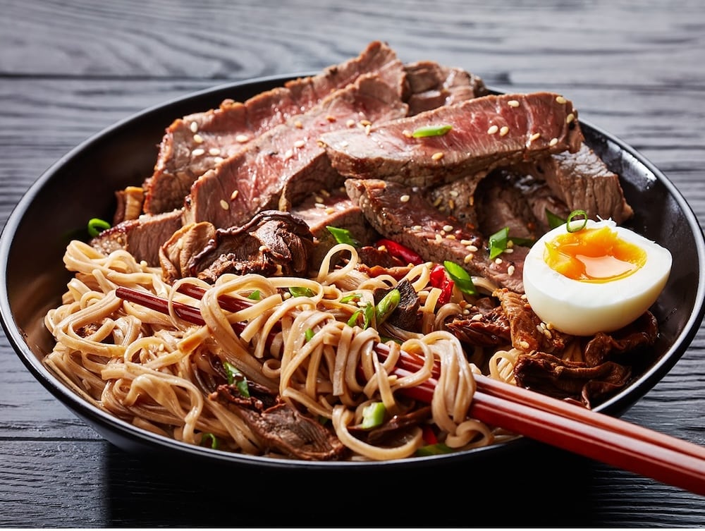 hanger steak in a bowl with rice and an egg