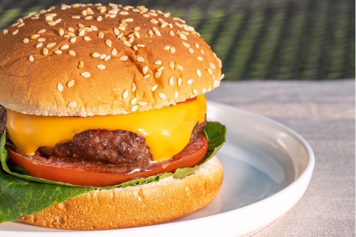 the ultimate burger with lettuce tomatoes onions pickles bacon mushrooms mayo ketchup and mustard